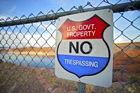 photo provided by http://www.123rf.com/photo_15485763_no-trespassing-us-government-property-warning-sign-on-fence.html